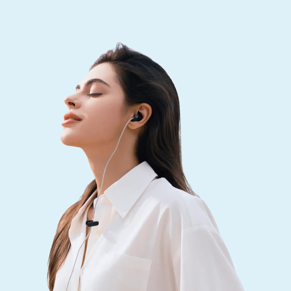 Woman relaxing while wearing an ear-based stimulation earpiece